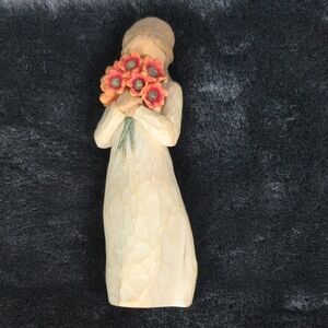 Figurine Holding Red Flowers